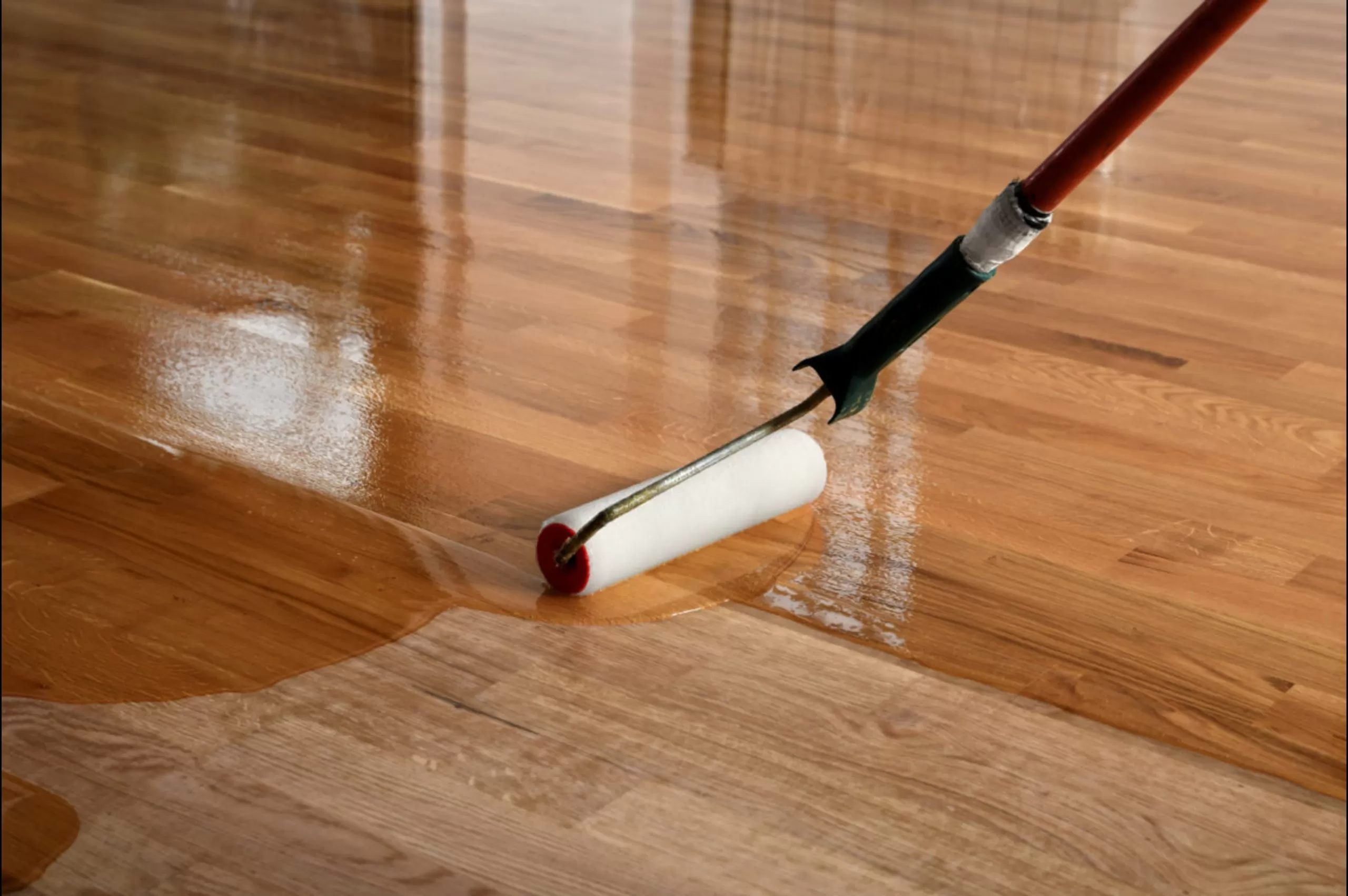Furious Fixes in Woking: clear coat rolled onto a solid oak plank hardwood floor to restore an even, protective satin sheen.
