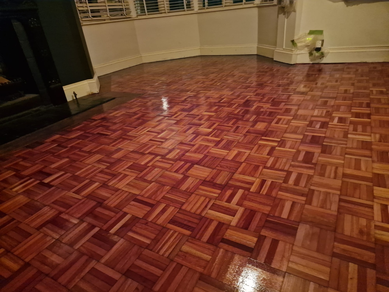 Wood Floor Sanding in Woking – fully restored oak mosaic parquet living room floor with a rich glossy finish after professional sanding and sealing.